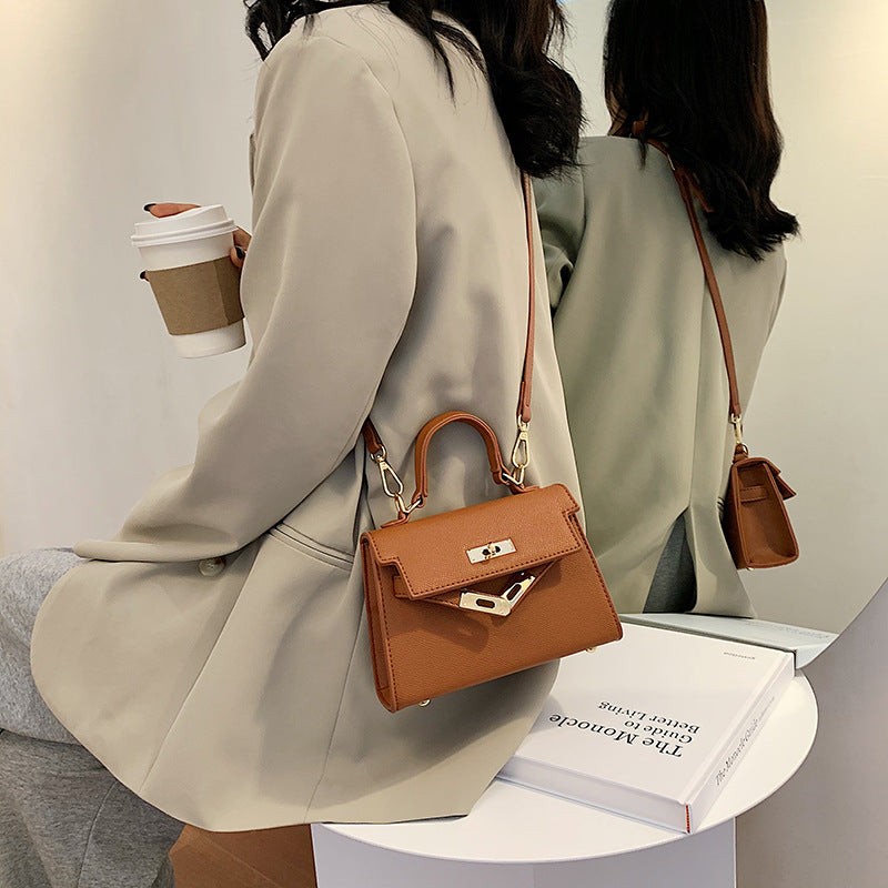 Carry a Kelly bag diagonally over one shoulder