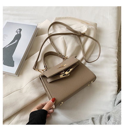 Carry a Kelly bag diagonally over one shoulder