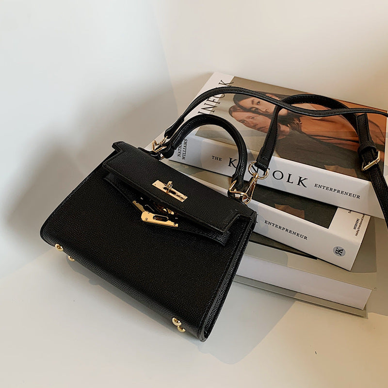 Carry a Kelly bag diagonally over one shoulder