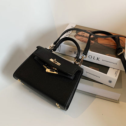 Carry a Kelly bag diagonally over one shoulder